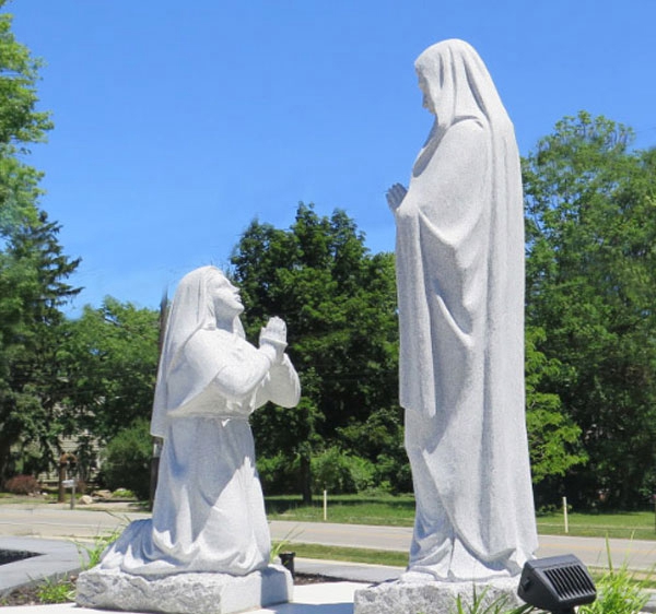 our lady of lourdes statue with bernadette